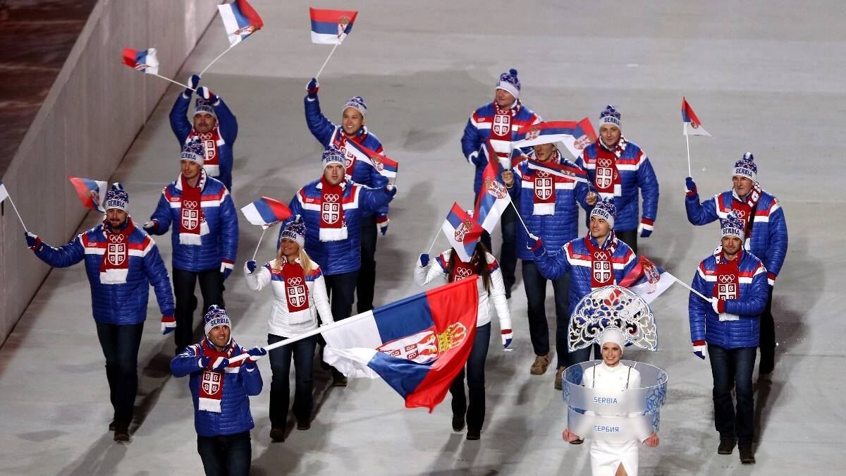 Biathlete Milanko Petrovic of the Serbia Olympic team carries his country's flag during the Opening Ceremony of the Sochi 2014 Winter Olympics. Picture: Getty