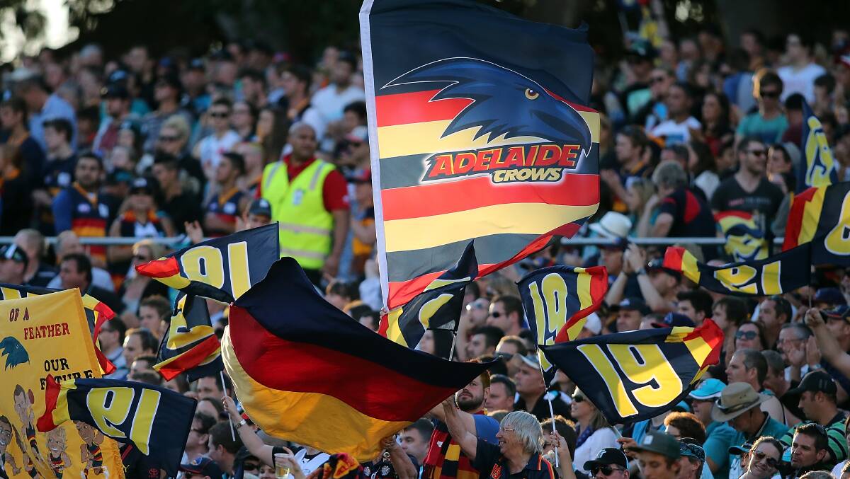 Crows supporters fly their flags during the round two AFL match between the Port Adelaide Power and the Adelaide Crows at Adelaide Oval. Photos: Getty