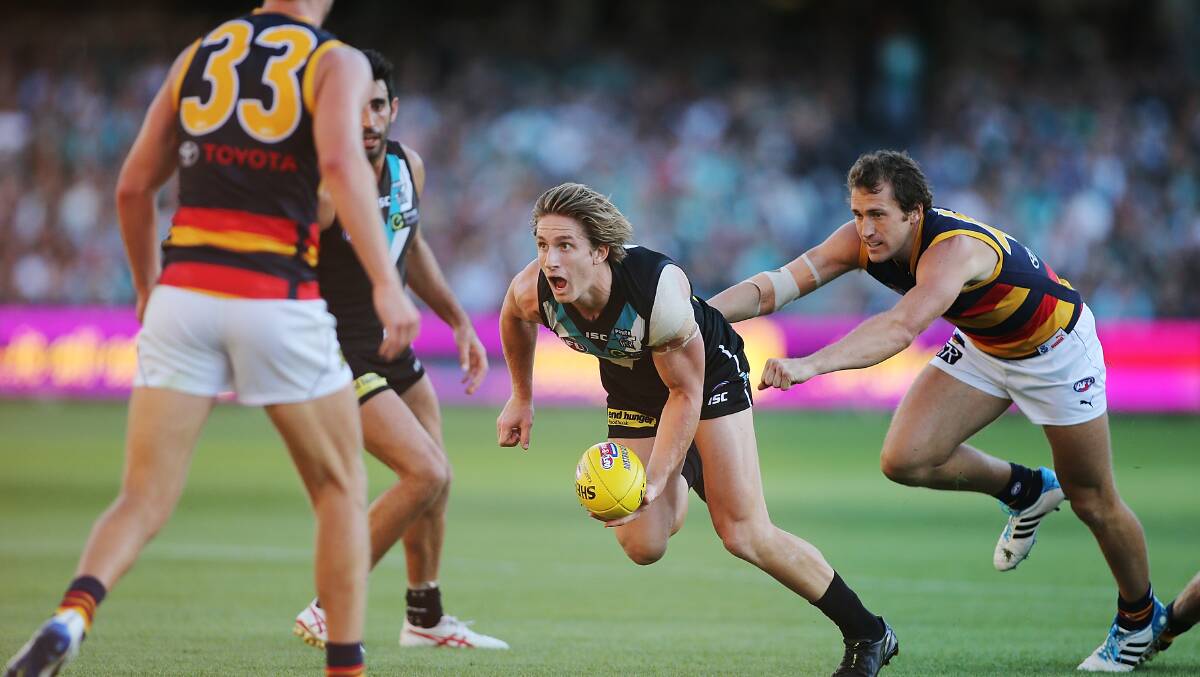 Hamish Hartlett of the Power runs with the ball during the round two AFL match between the Port Adelaide Power and the Adelaide Crows at Adelaide Oval. Photos: Getty
