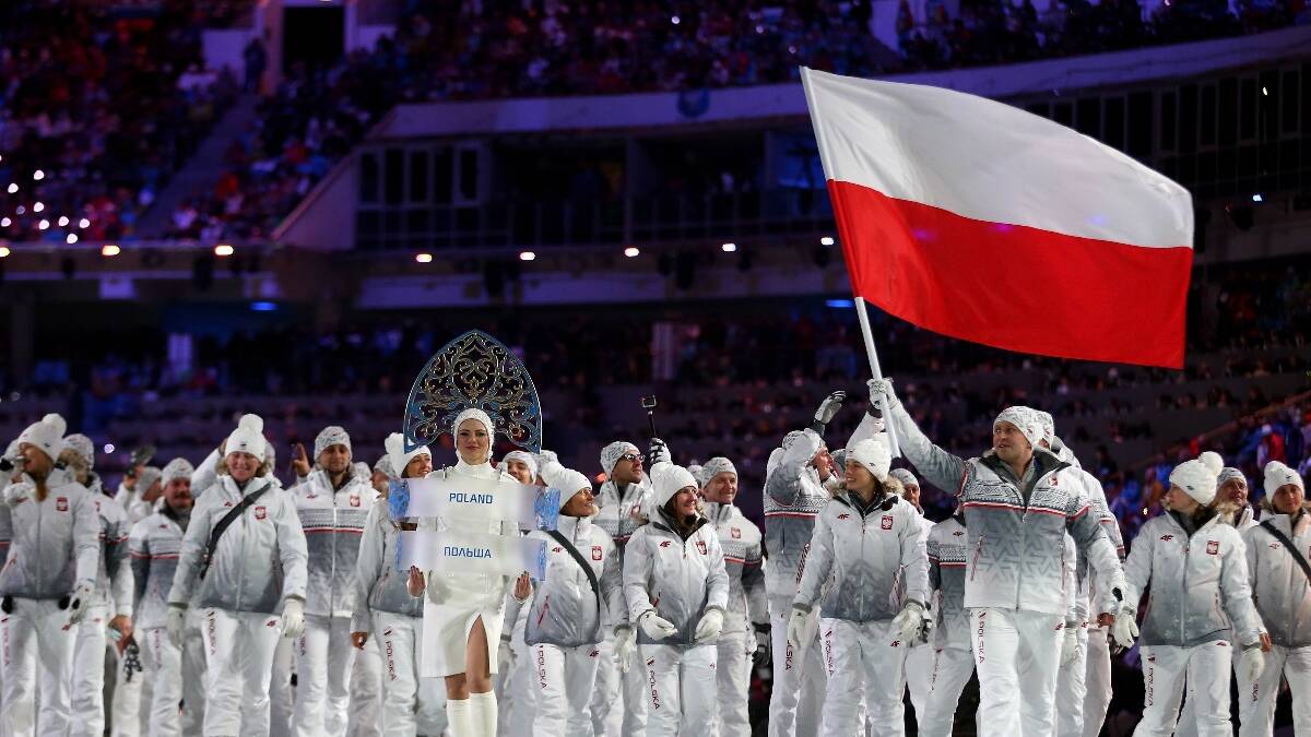 Bobsleigh racer Dawid Kupczyk of the Poland Olympic team carries his country's flag during the Opening Ceremony of the Sochi 2014 Winter Olympics. Picture: Getty