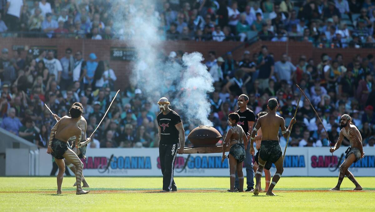 Indigenous performers carry out the 'Welcome to Country' ceremony before the round two AFL match between the Port Adelaide Power and the Adelaide Crows. Photos: Getty