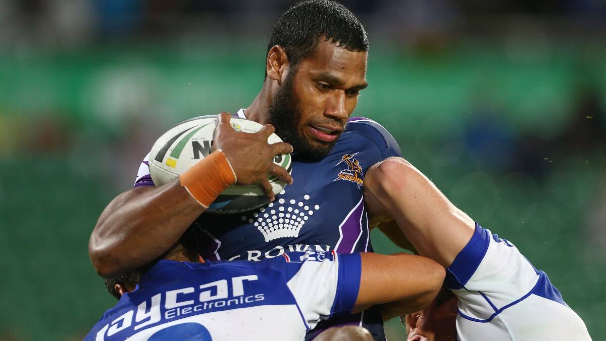 Sisa Waqa of the Storm is tackled by the Bulldogs defence. Picture: Getty