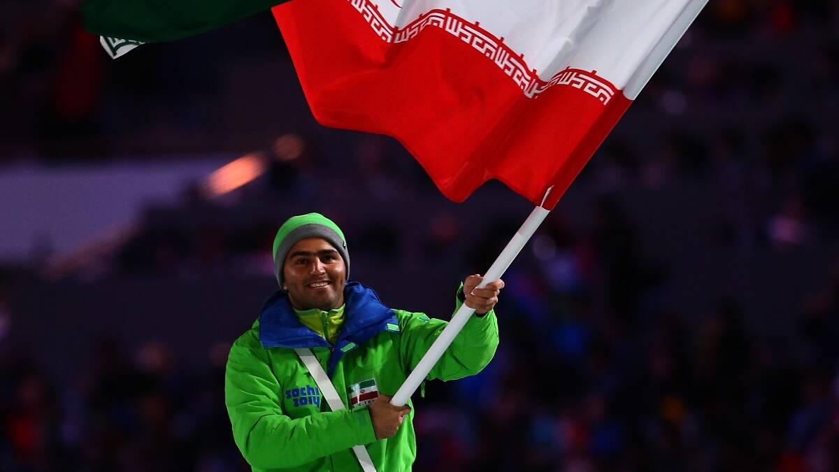 Skier Hossein Saveh Shemshaki of the Iran Olympic team carries his country's flag during the Opening Ceremony of the Sochi 2014 Winter Olympics. Picture: Getty