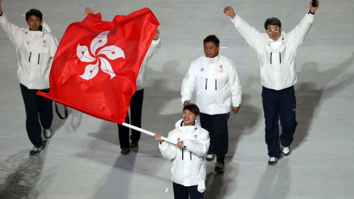 hort track speed skater Pan-To Barton Lui of the Hong Kong Olympic team carries his country's flag during the Opening Ceremony of the Sochi 2014 Winter Olympics. Picture: Getty