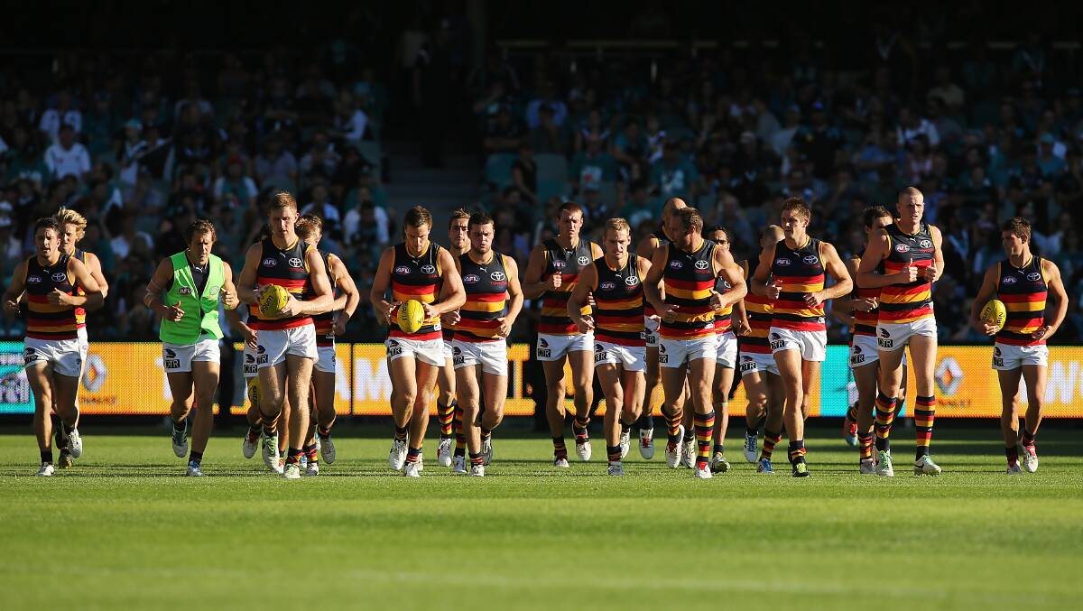 Crows players warm up after half time during the round two AFL match between the Port Adelaide Power and the Adelaide Crows. Photos: Getty