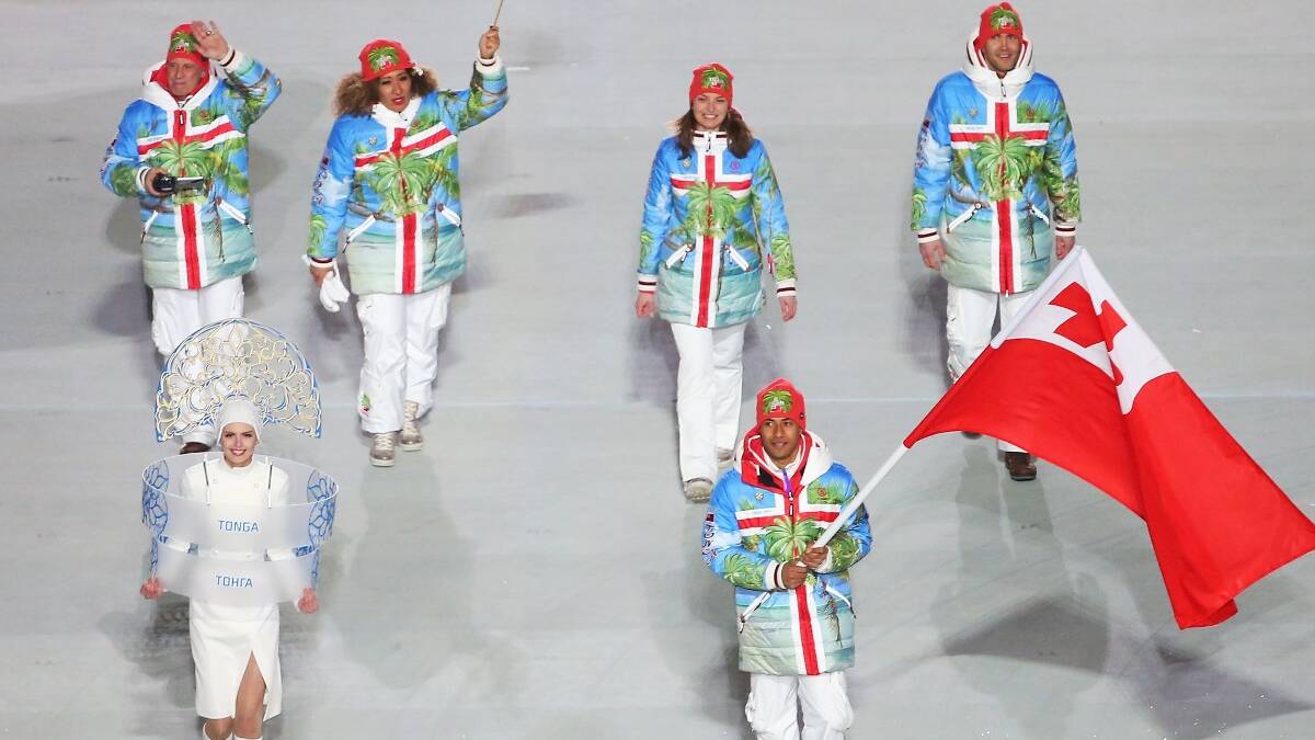 Luger Bruno Banani of the Tonga Olympic team carries his country's flag during the Opening Ceremony of the Sochi 2014 Winter Olympics. Picture: Getty