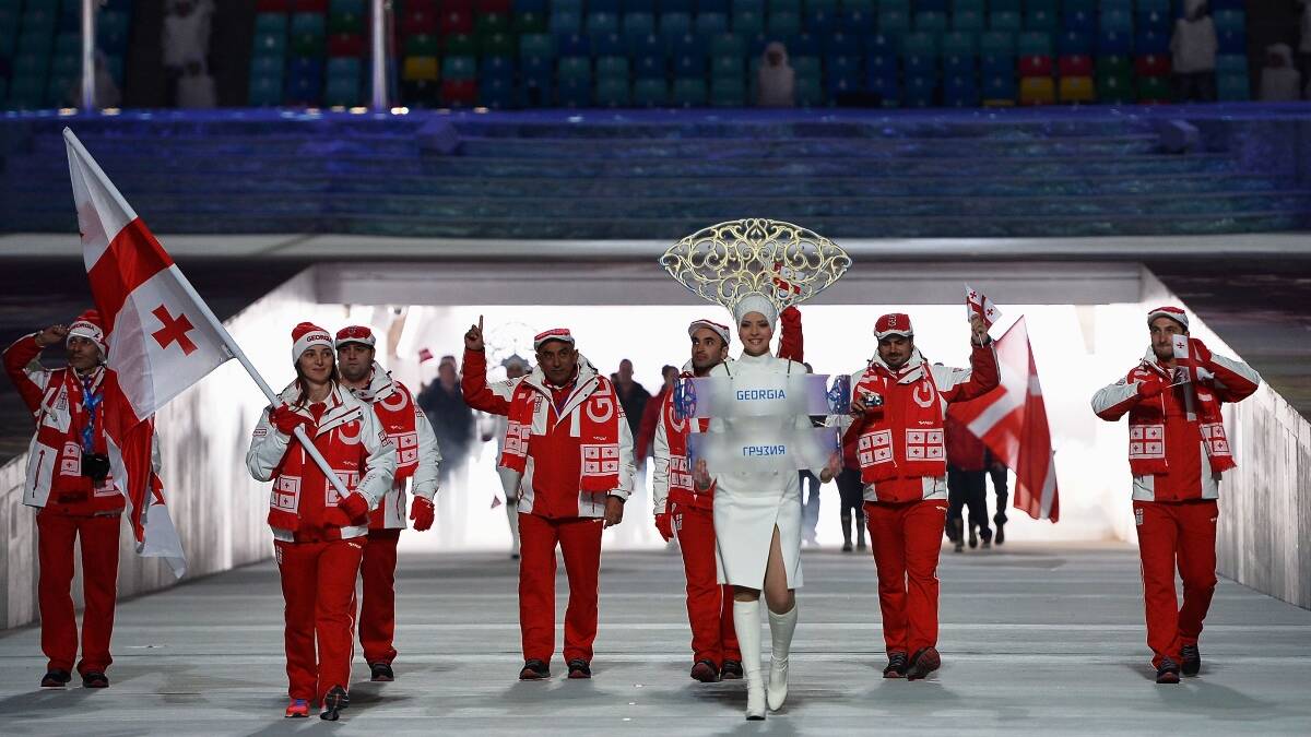 Skier Nino Tsiklauri of the Georgia Olympic team carries her country's flag during the Opening Ceremony of the Sochi 2014 Winter Olympics. Picture: Getty