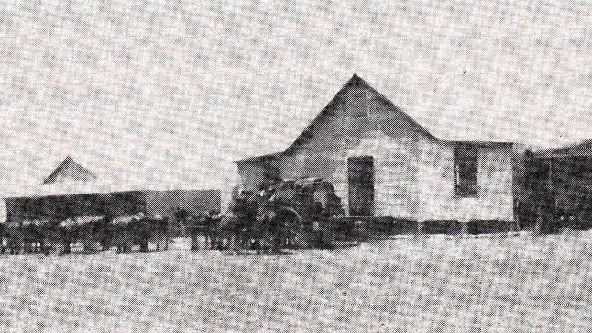 Unloading supplies from Burketown into Synnot’s Store, Camooweal  ca 1890.