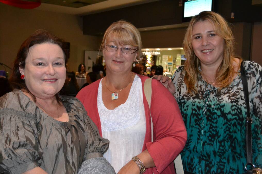 PHOTO TIME: Marie Breen, Tracey Hudson-James and Jasmina Ribor are keen to watch the fashion parade.