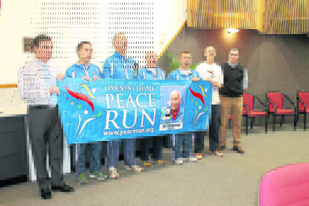 PEACE RUN: Tony McGrady joined with the Sri Chimnoy Oneness-Home Peace Run Australia team members Noivedya Juddery, Prachar Stegemann, Steven Elliot, Ion Frunza and Samalya Schaefer and State Member for Mount Isa Rob Katter to hear their welcoming song.