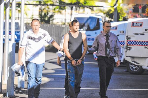 CAUGHT FOR COURT: Aaron Jon Woodsbey (centre) is taken to the Townsville watchhouse for questioning charged with the murder of Mount Isa man Aaron Macfarlane. -Picture: RADFORD-CHISHOLM SCOTT