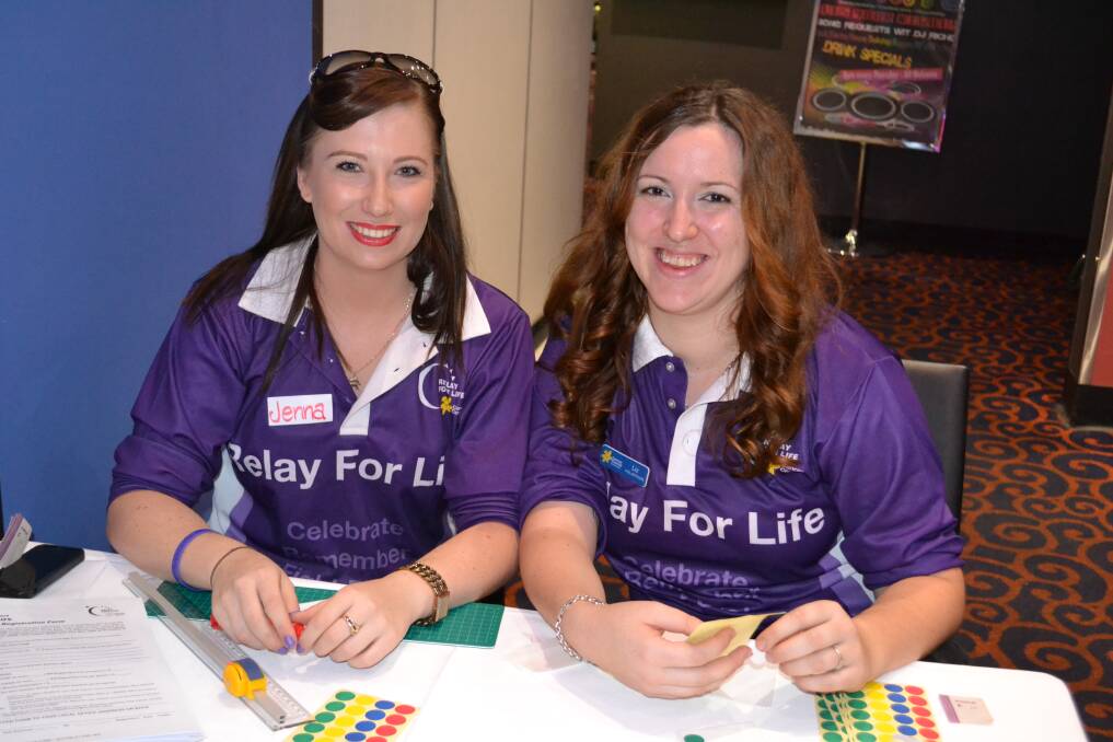 WORKING HARD: Jenna Fyfe and Eliza Buckland at the door at the Relay for Life launch.