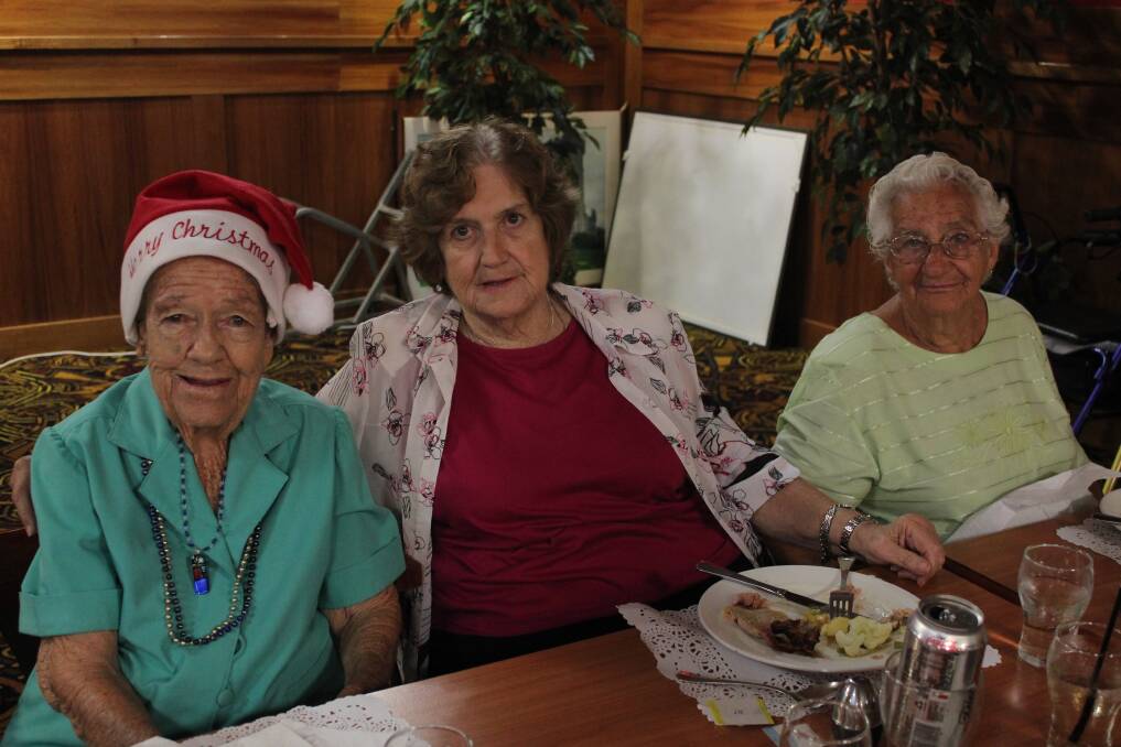 CHEER: Marie Poppell, Marie McKay and Daphne Doak dressed up in Christmas colours.