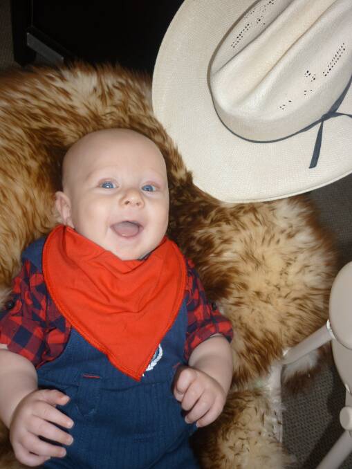 RODEO BABY: Finn Wilkins, four months, shows how easy it is to get into the rodeo action by taking part in the Bandana Bib Bub of Mount Isa Rodeo 2013 competition. -zz