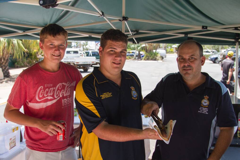 SAUSAGE SIZZLE: Air Force Cadets Mitchell Lewis, James Glasson and Matt Cohen worked the barbecue all day to support the fundraiser.