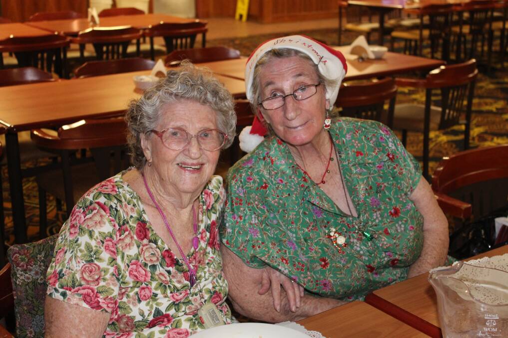 SPIRIT: Muriel Morris and Loraine Salmon get into the Christmas spirit.