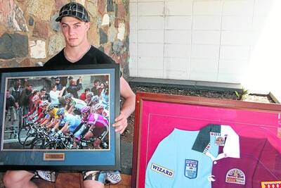 MATE: Daniel Graham with some of the sporting memorabilia to be auctioned at the Overlander Hotel on Sunday from 2.30pm, with funds to go to the families of his friends, murdered couple Scott Maitland and Cindy Masonwells. Picture: JOHN SCHALCH.