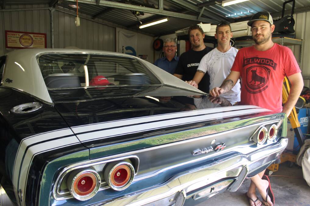 FLEXING THEIR MUSCLE: Mount Isa Muscle Association founder Ben McDonald shows off his metallic blue Dodge Charger to fellow members Darren Marsh, Stuart Cameron and Ron Pertovt. - Picture: HAILEY RENAULT/7235