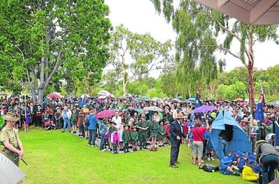 GATHERING: Umbrellas bloomed under the gentle rain at the main Anzac Day service at George McCoy Park.
