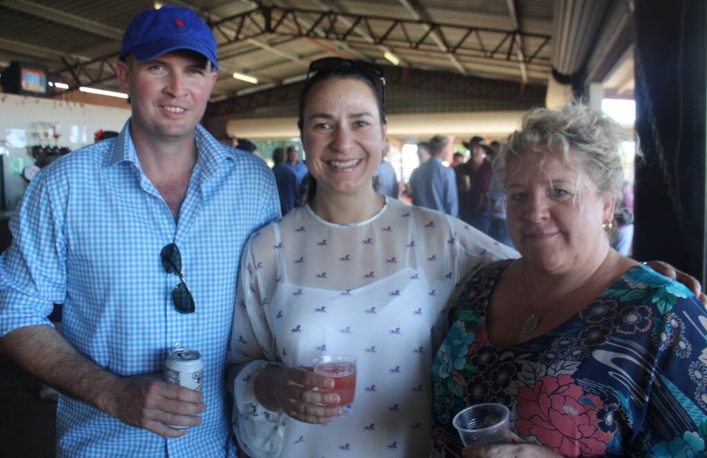 CHEERS: Greg Campbell, Anna Campbell and Paula Booth shared a drink at the races.