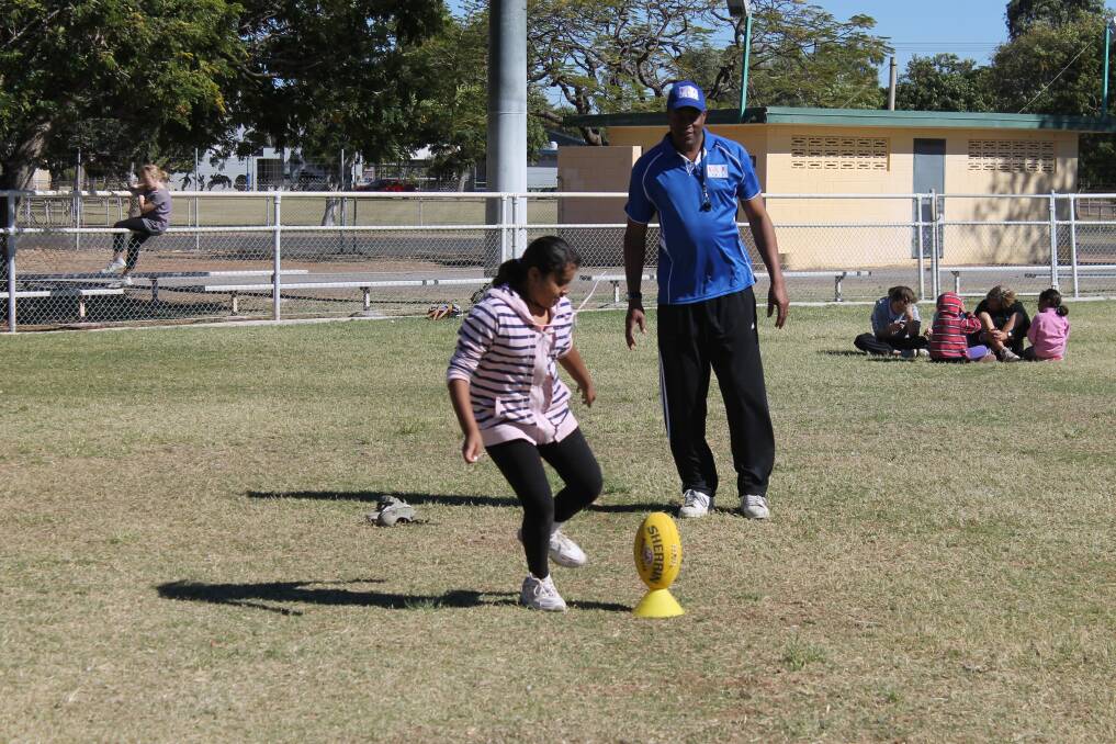 AFL FUN: Krishma Ramdeo gives AFL a go during the 'On the Ball' school holiday program brought to Cloncurry by Stride.