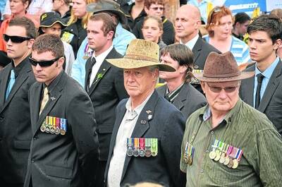 HONOURED: Returned servicemen brave the rain, assembling at George McCoy Park after the march.