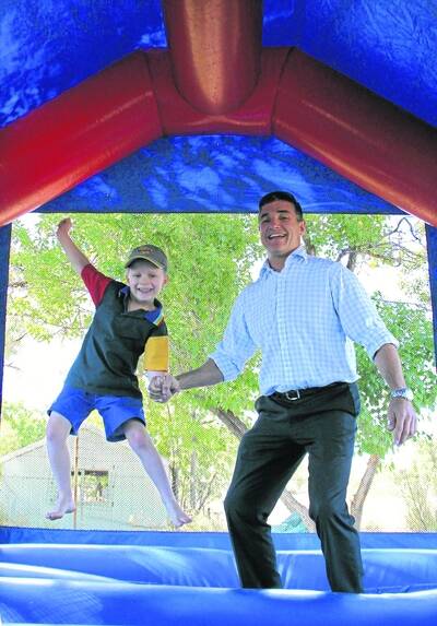 KATTER'S CASTLE: Member for Mount Isa Robbie Katter kicked off his shoes yesterday to lead by example on the jumping castle yesterday alongside Tom O'Neill, 5. - Picture: CHANELLE SZMOLNIK