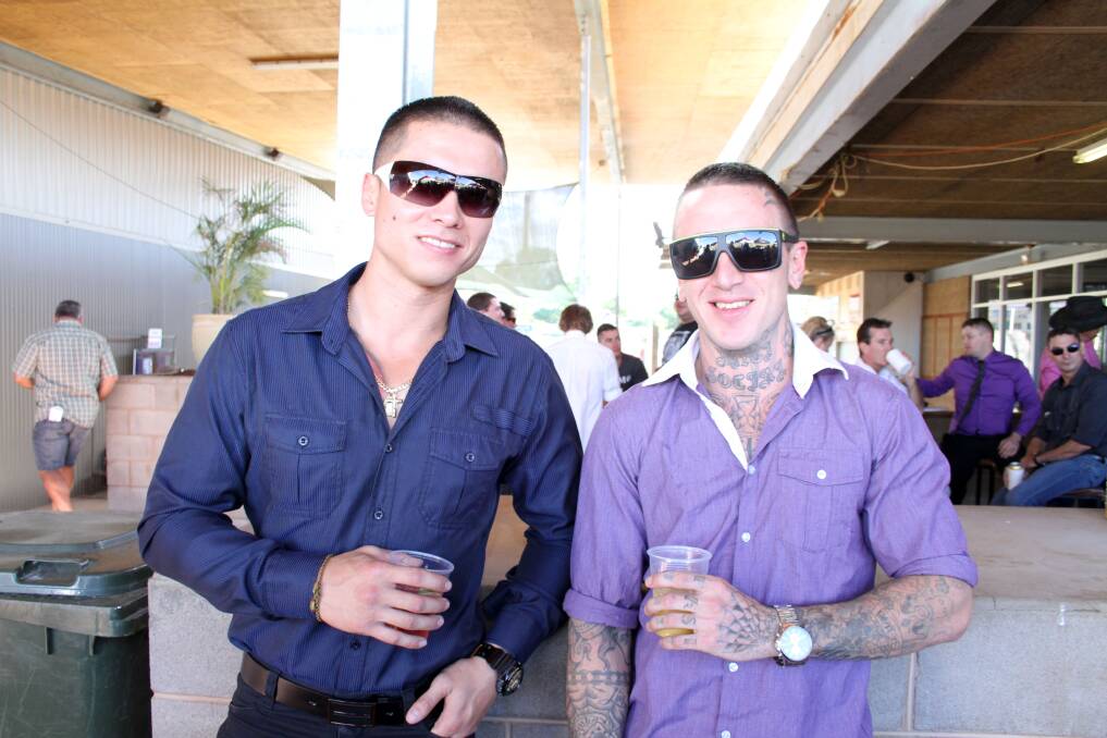 CHEERS: Michael New and Josh Blight have a drink at the races.