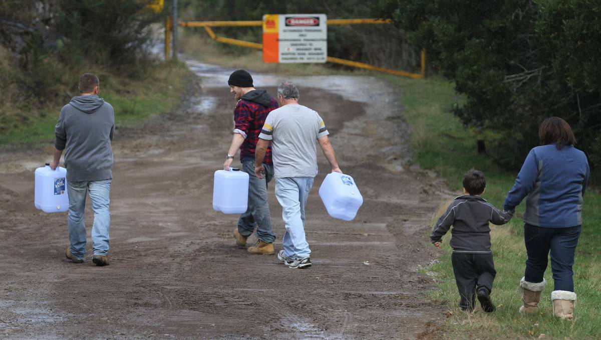 Residents in Rosebery, Tasmania head to the hydrant to collect drinking water after their supply tested three times higher than the Australian drinking water guidelines for lead. Photo: Grant Wells.