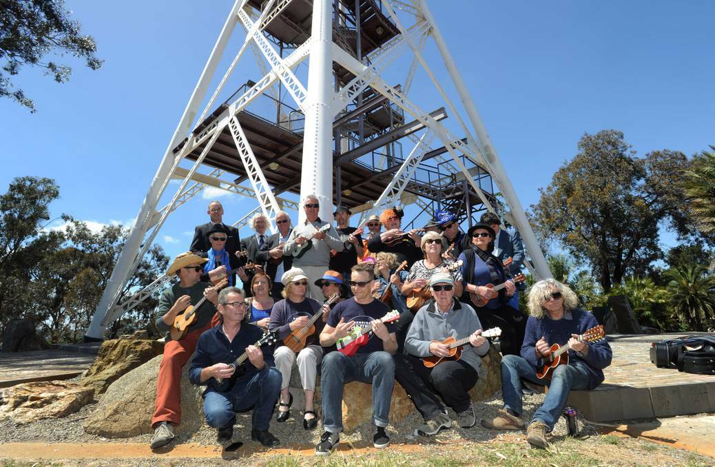  Ukulele players launch the Bendigo Blues and Roots Music Festival from the top of the poppet head. Picture: JODIE DONNELLAN