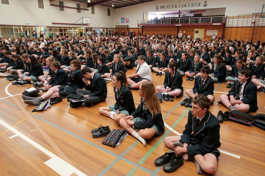 Students sit during Brauer College's Remembrance Day ceremony. Picture: ROB GUNSTONE