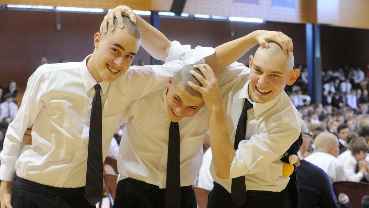 Ollie Cox, Sam Webb and Brenton Apostolou of Girton Grammar in Bendigo celebrate after shaving their heads for a cure to cancer. Picture: Jodie Donnellan
