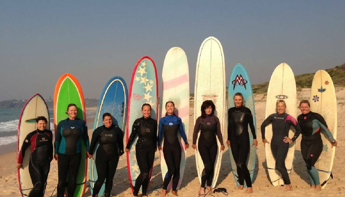  Members of the "Kianga Doves" women's surfing group on the beach at Bendelong, highlighting the advantages of women taking up surfing later in life.