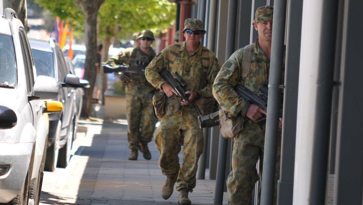Army reservists patrol the township of Clare in South Australia on Sunday afternoon as part of a training exercise.