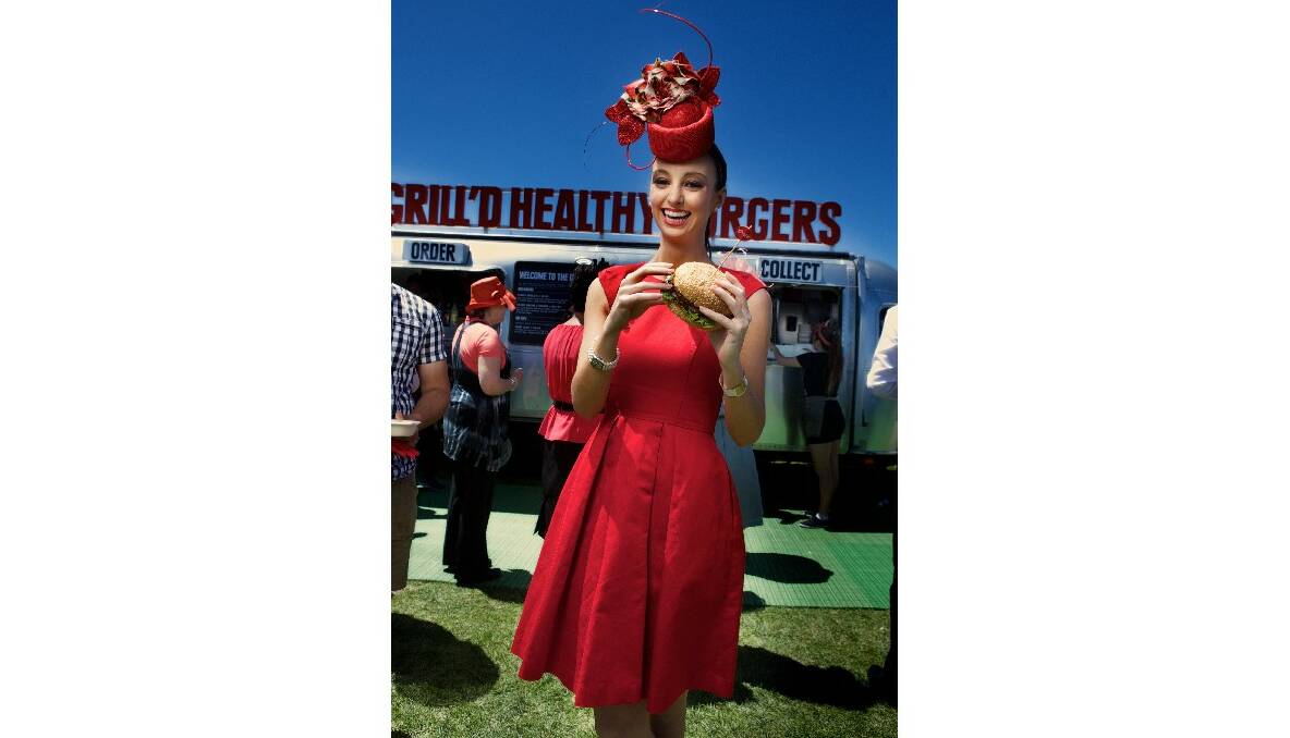 Lex Hecker wearing a Cue dress and in a Rebecca Share hat at the Melbourne Cup Fashions on the Field. Picture by Simon Schluter.