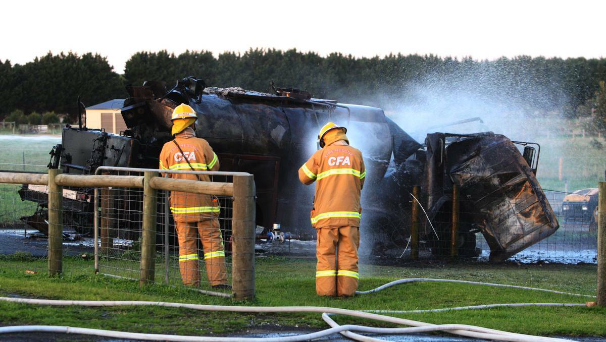 CFA firefighters survey the damaged remains of a council truck that exploded in Port Fairy. Picture: Leanne Pickett.