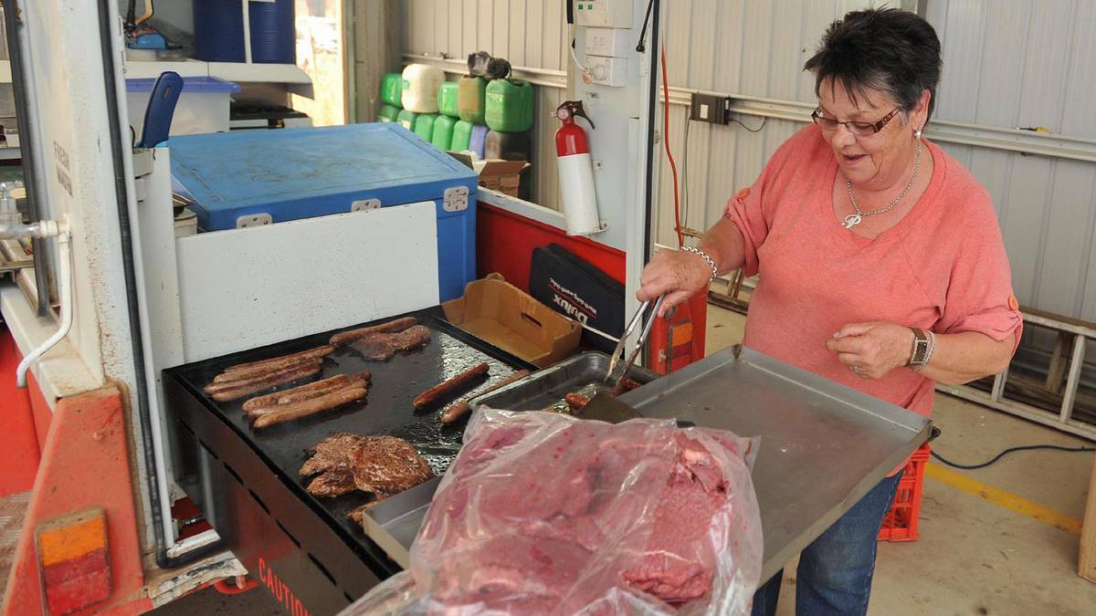 Pauline Turner cooks up a barbecue for the firefighters in Stockinbingal. Picture: Michael Frogley