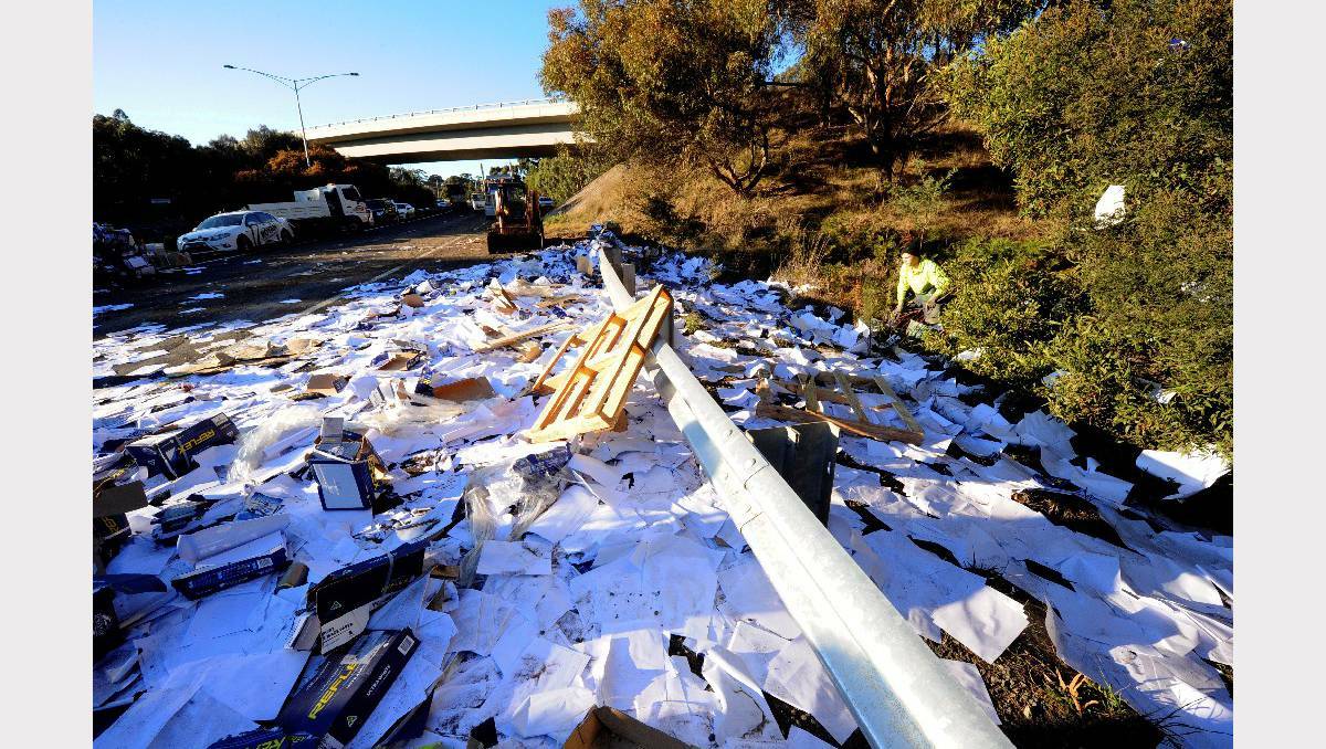 Parcels and paper are strewn over the freeway after a B-double truck rolled on Wednesday morning. Picture: Jeremy Bannister.