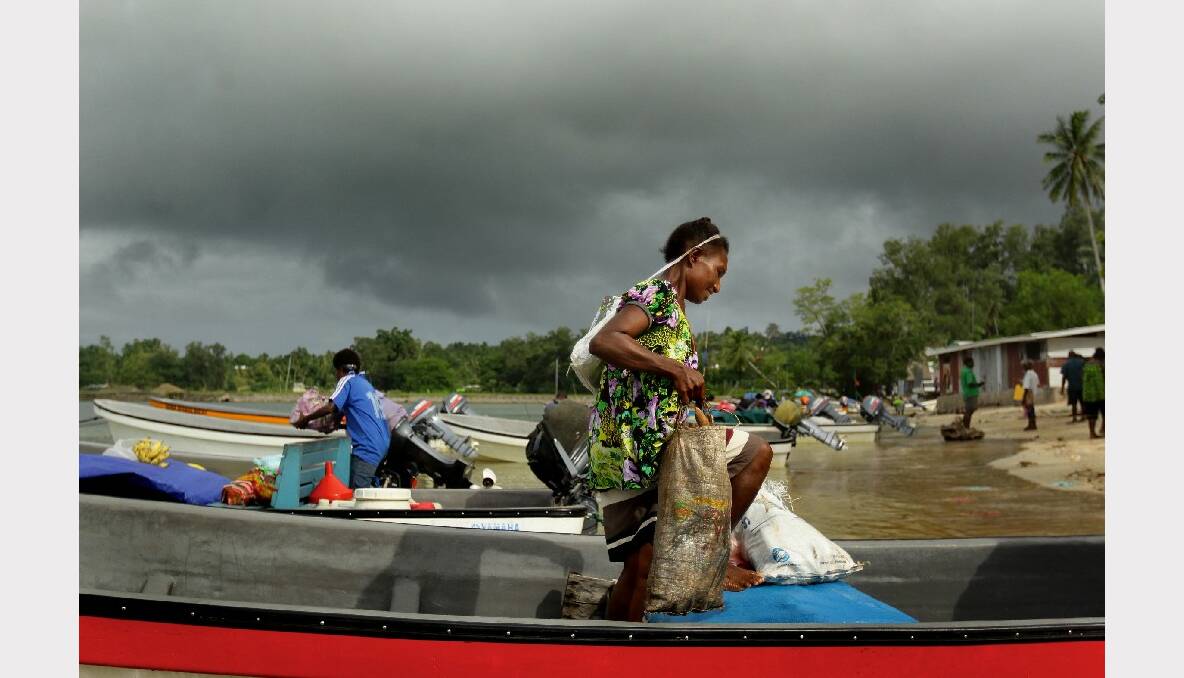 A woman arrives by boat at the main town Lorengau on Manus Island in Papua New Guinea. Photo: Kate Geraghty