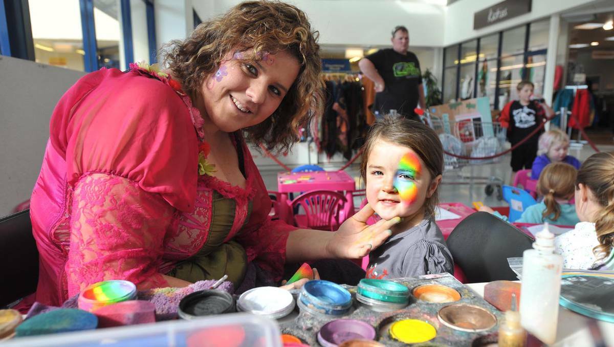 Face painting and colouring in at the Sturt Mall. Renee Bickford painting Stella Grintell's, 4, face. Picture Alastair Brook.