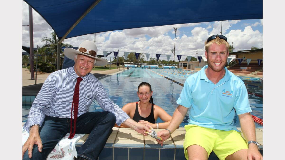 DEDICATION: Federal member for Kennedy Bob Katter and Splashez Aquatic Centre manager Brian Rodriquez cheer on Anne Pleash as she trains for a 20-kilometre swim to raise money for struggling graziers. Picture: KATE GLOVER/8807 