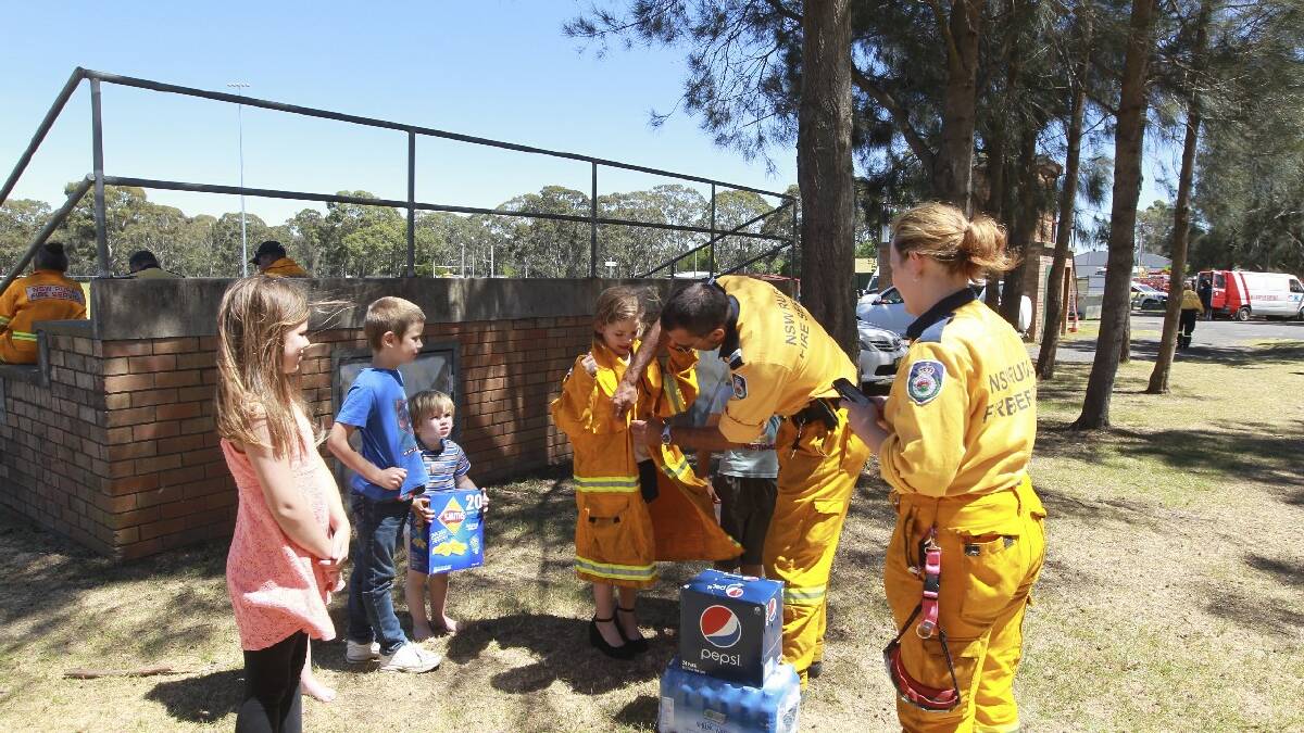 Firefighters at Bargo Oval in the Southern Highlands accept food donated by the Bennett family today at Bargo Oval. Picture: Sahlan Hayes, SMH News. 
