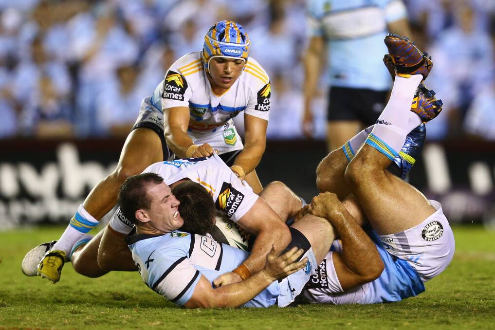 Paul Gallen of the Sharks is tackled during the round one NRL match between the Cronulla Sharks and the Gold Coast Titans. Photo by Mark Kolbe/Getty Images