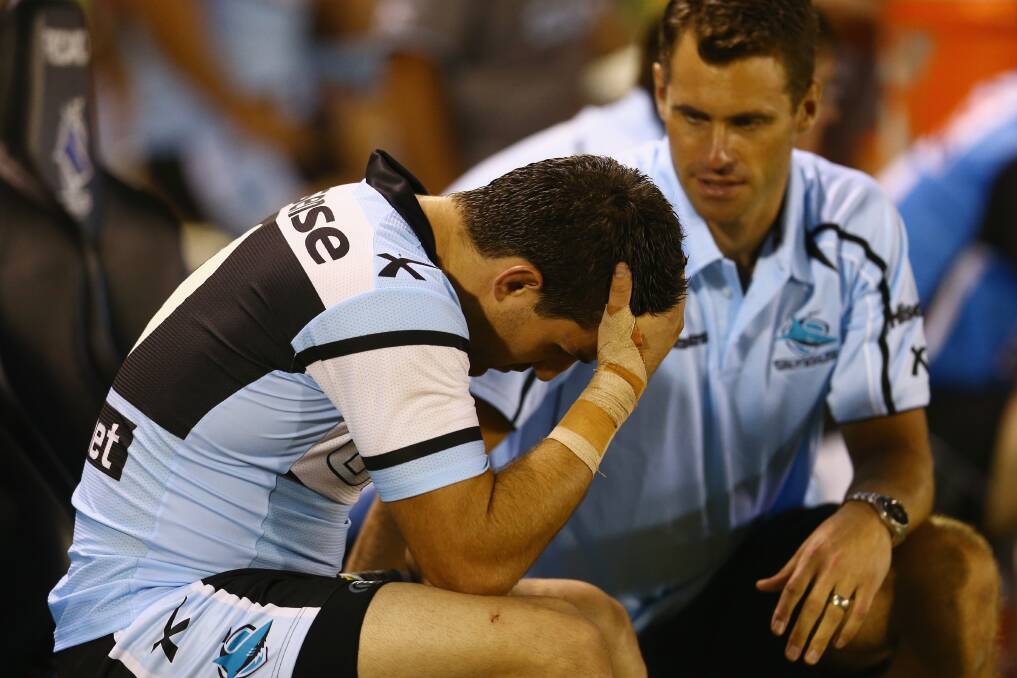 Isaac De Gois of the Sharks speaks to trainer as he sits on the bench. Photo by Mark Kolbe/Getty Images