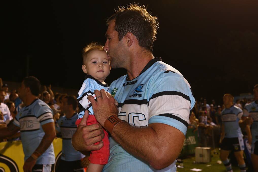 Ben Ross of the Sharks celebrates with his child after the Sharks won. Photo by Mark Kolbe/Getty Images