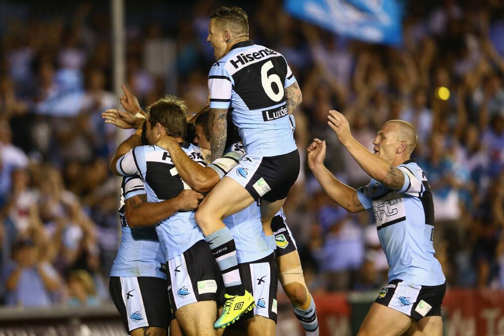 The Sharks players celebrate with Andrew Fifita of the Sharks. Photo by Mark Kolbe/Getty Images