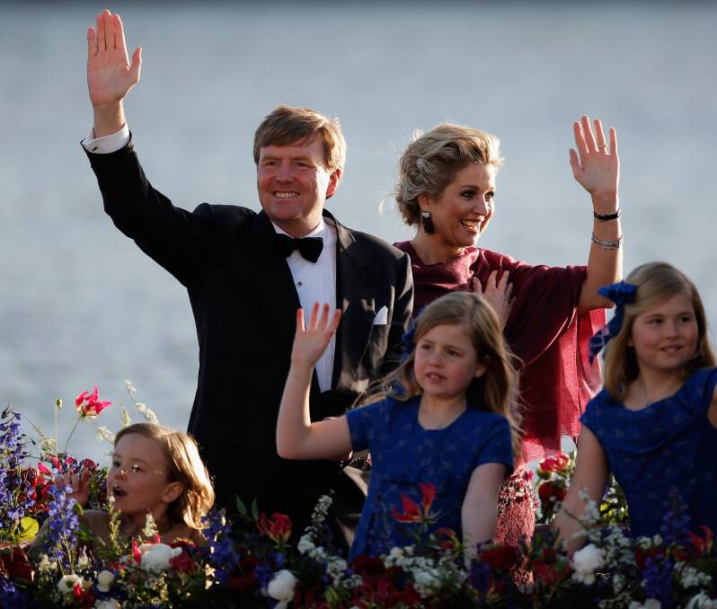 King Willem Alexander and Queen Maxima of The Netherlands are seen aboard the Kings boat for the water pageant. Photo by Chris Jackson/Getty Images