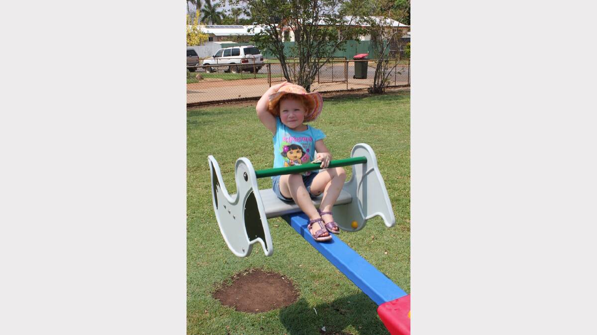 SUNSAFE: Liane van Lelyveld, 3, holds on to her hat whilst on the see-saw.