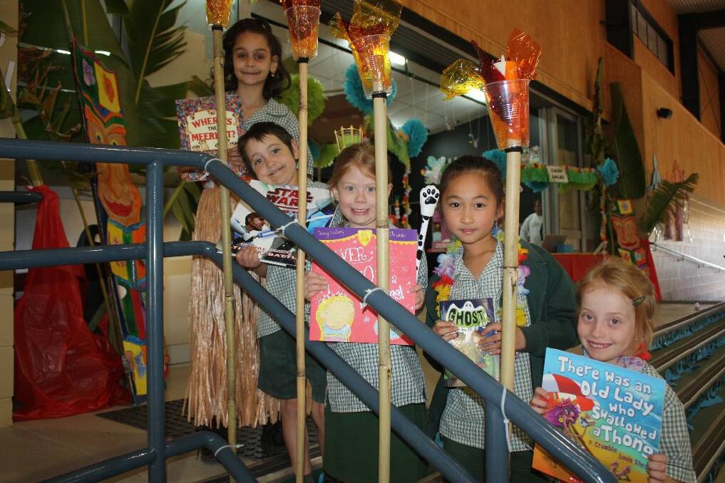 HAWAIIAN THEMED: Shekinah Coady, 8, San-San Huang, 7, Elizabeth Elliott, 7, Will Calrand, 7, and Shannon Harvey, 7, show off some books available at this year's St Joseph's Primary School book fair. - Picture: CHANELLE SZMOLNIK