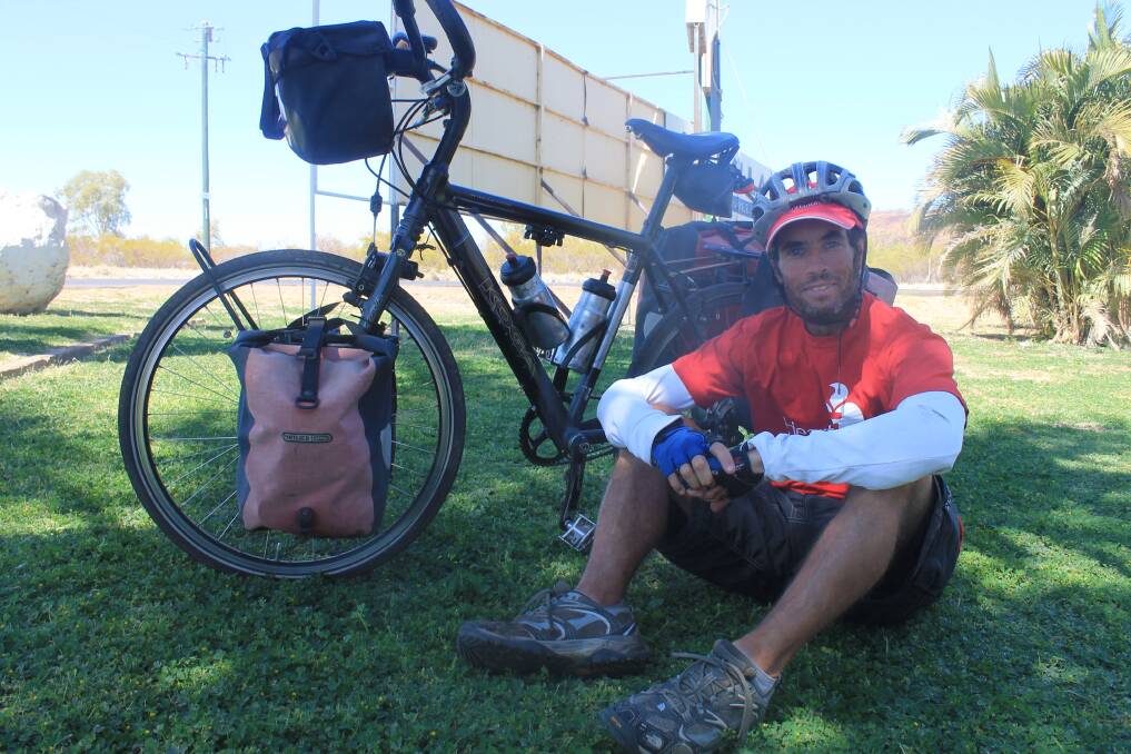 DETERMINED: Charity bike rider Jeremy Scott stopped for a much-needed break in Mount Isa yesterday. – Picture: EMMA KENNEDY/7788